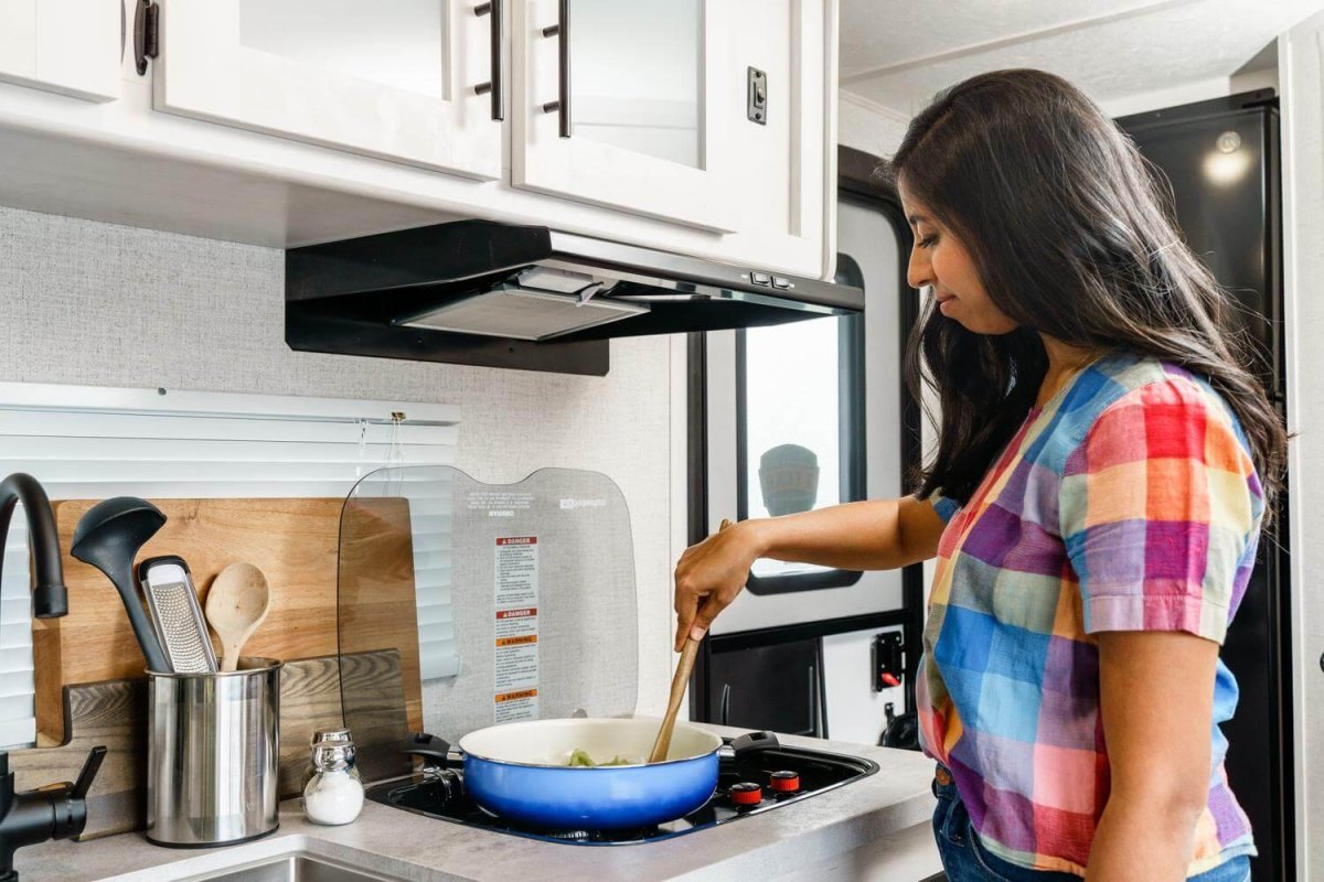 Traveler cooking efficiently in RV kitchen