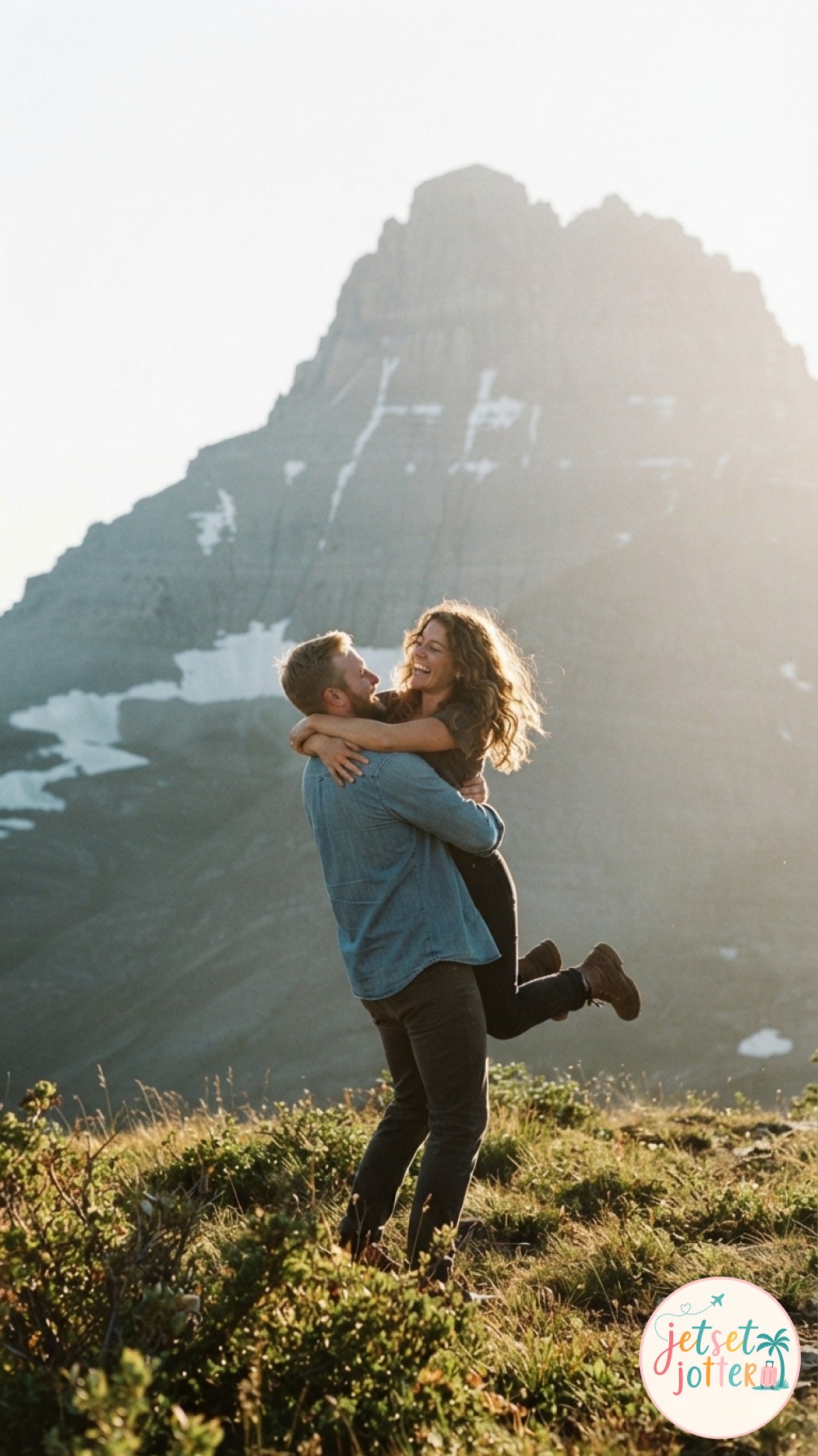 A simple hiking couple photo idea pointing toward distant peaks at a golden-lit viewpoint.