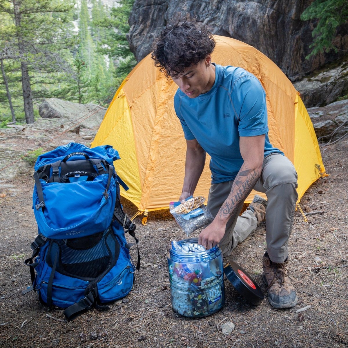 Backpacker storing food outdoors