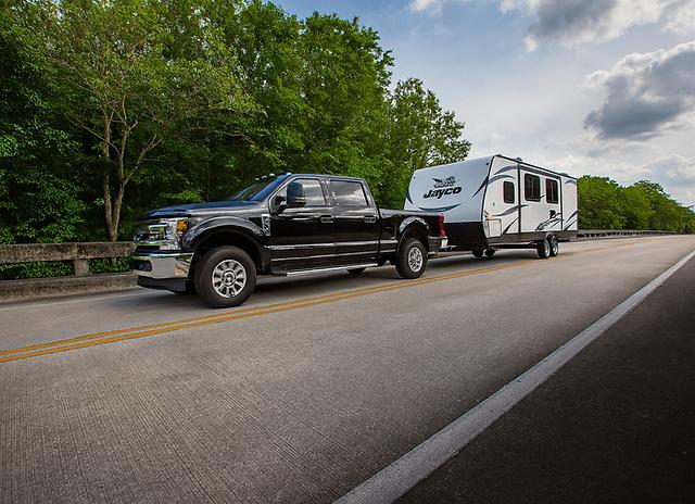 Truck towing travel trailer highway
