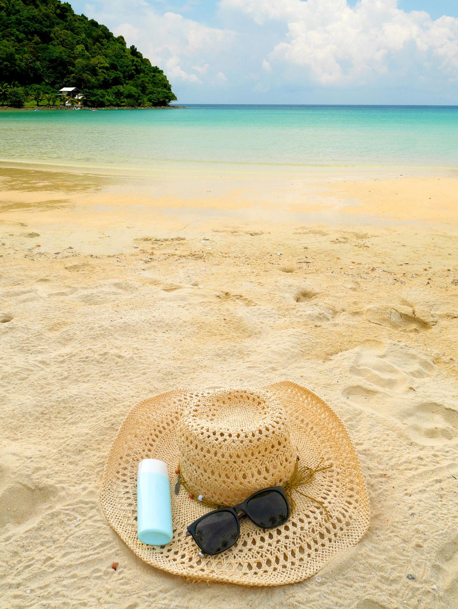 Sunscreen hat sunglasses travel essentials
