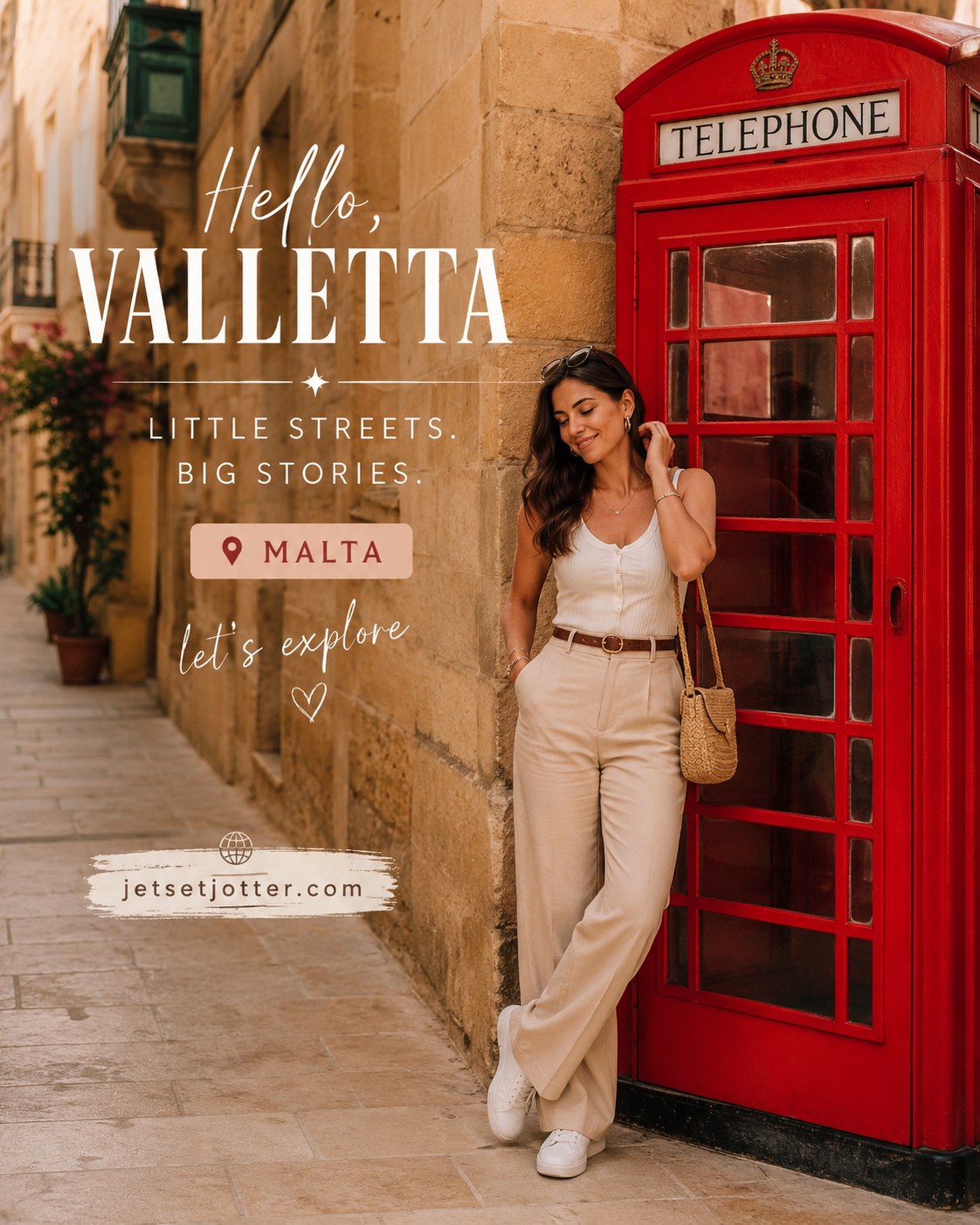Woman in beige outfit posing beside a red telephone booth on a narrow limestone street in Valletta